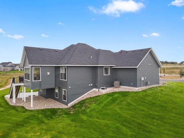 back of house with central AC unit, a yard, and a patio area