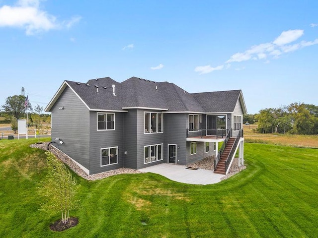 rear view of property with a patio area and a lawn