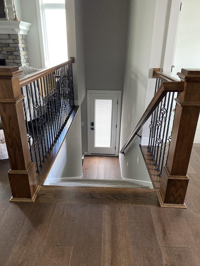 staircase with wood-type flooring and a high ceiling