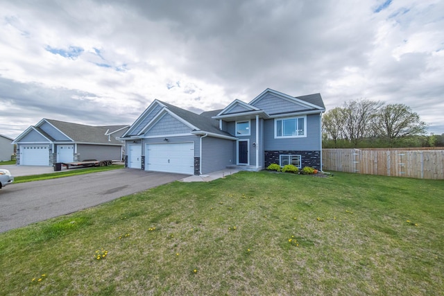 view of front of property featuring a front yard and a garage