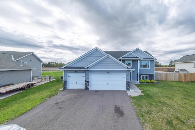 view of front of home with cooling unit, a front lawn, and a garage