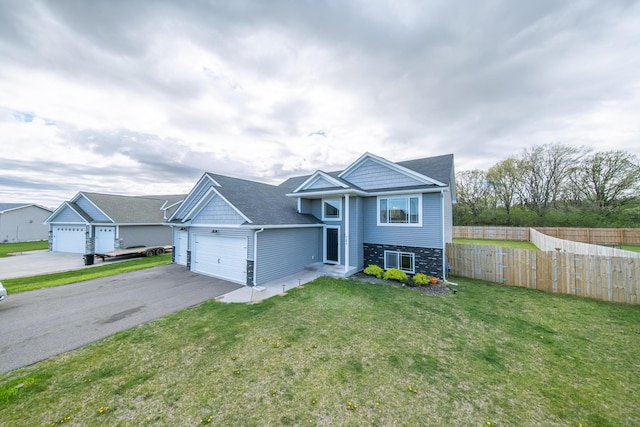 split foyer home with a front yard and a garage