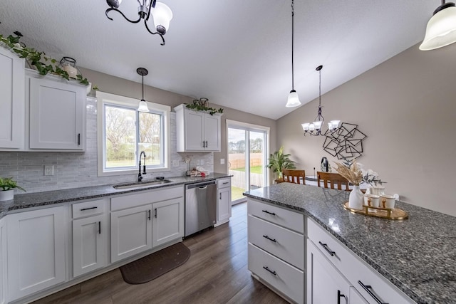 kitchen featuring dark hardwood / wood-style floors, sink, white cabinetry, an inviting chandelier, and stainless steel dishwasher