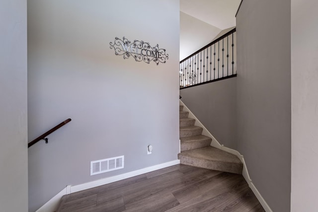 staircase featuring wood-type flooring