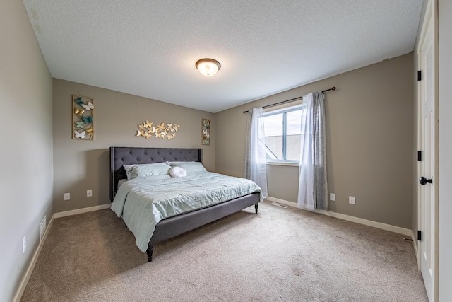 carpeted bedroom featuring a textured ceiling