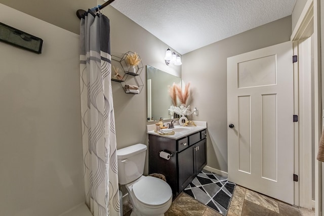 bathroom featuring a textured ceiling, curtained shower, vanity, and toilet