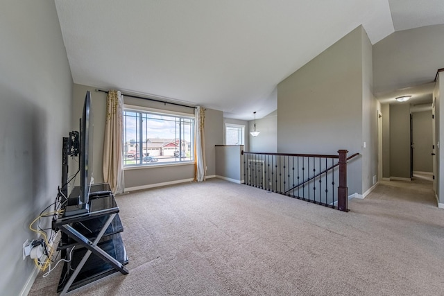 unfurnished living room with carpet and lofted ceiling