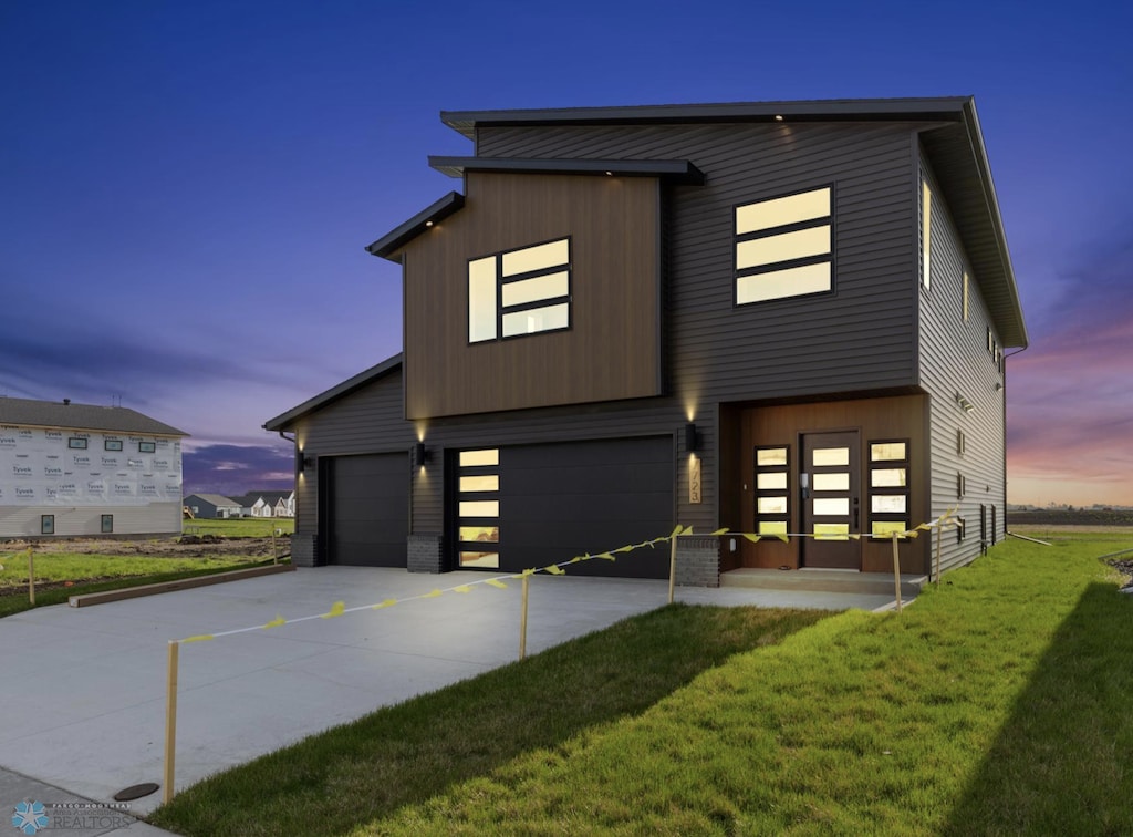 contemporary house with a yard and a garage