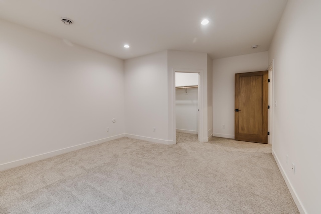 unfurnished room featuring light carpet