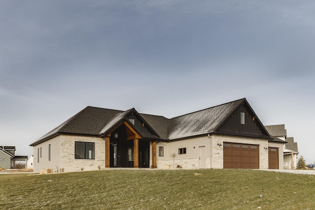 view of front of home with a garage and a front lawn