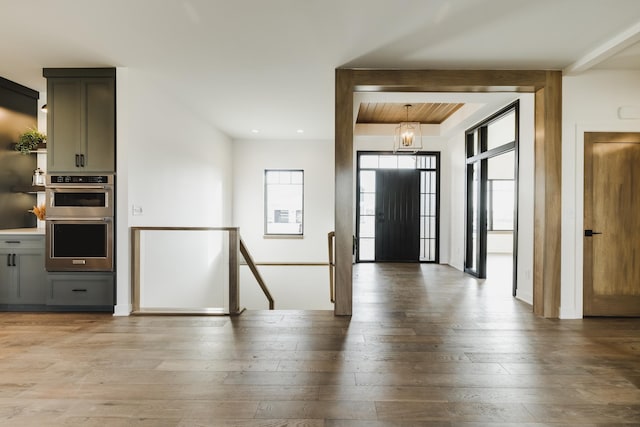 entrance foyer with a notable chandelier and light hardwood / wood-style floors