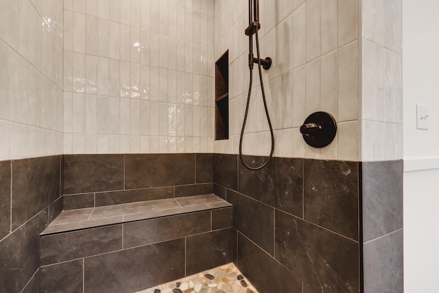 bathroom with tiled shower