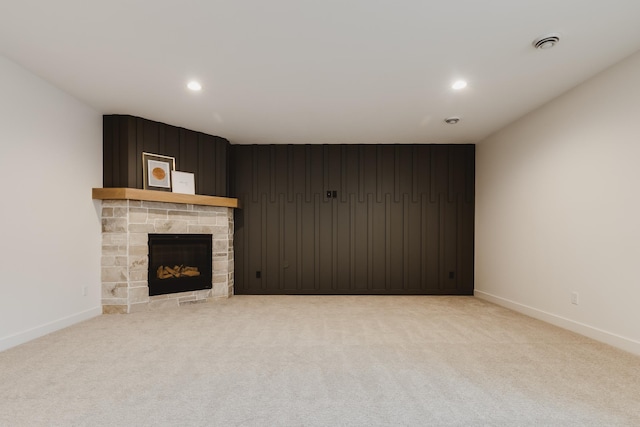 unfurnished living room featuring carpet flooring and a fireplace