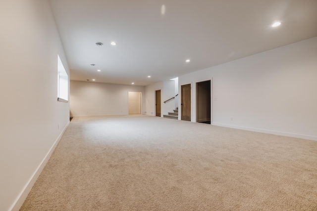 spare room featuring light colored carpet