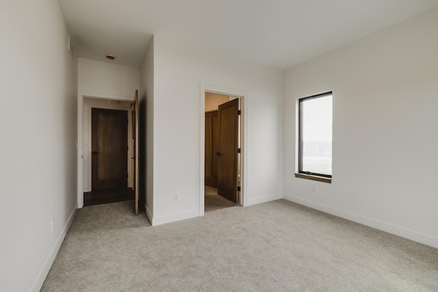 unfurnished bedroom with light colored carpet