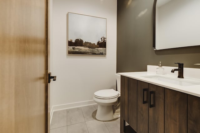 bathroom featuring tile patterned flooring, vanity, and toilet