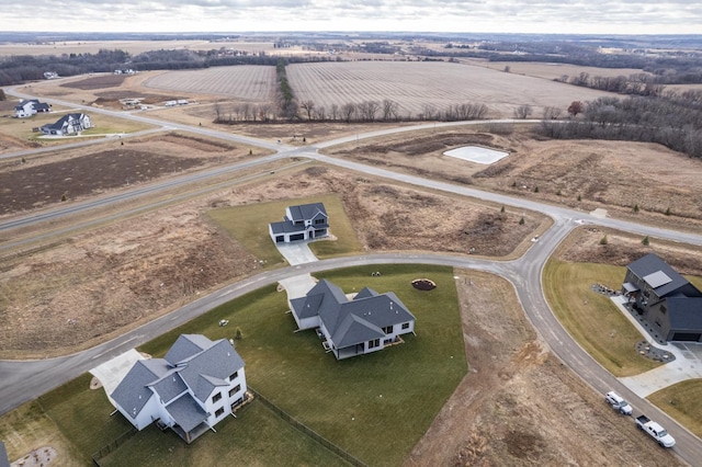 birds eye view of property with a rural view