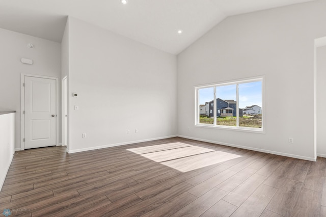 unfurnished living room featuring dark hardwood / wood-style floors and high vaulted ceiling