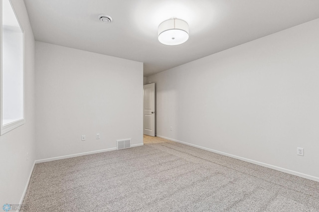 empty room featuring light colored carpet