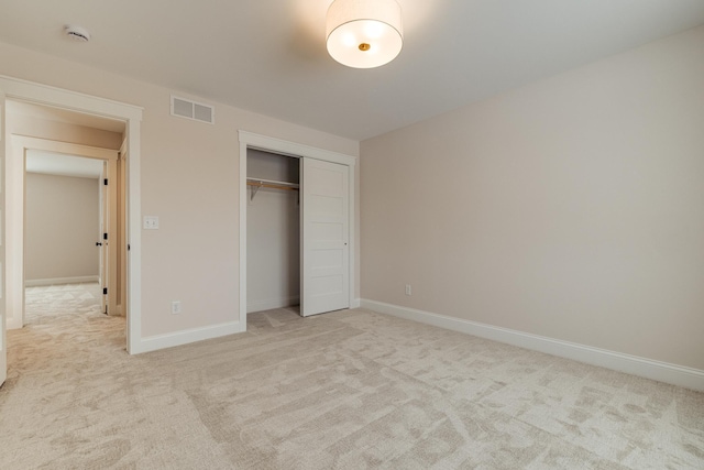 unfurnished bedroom featuring light carpet, visible vents, and baseboards