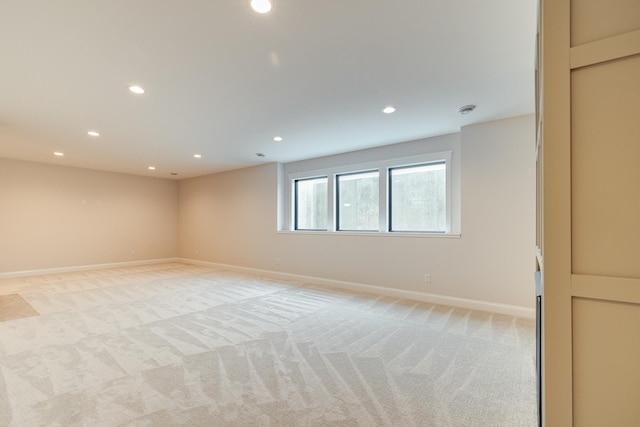 unfurnished room with light carpet, baseboards, and recessed lighting