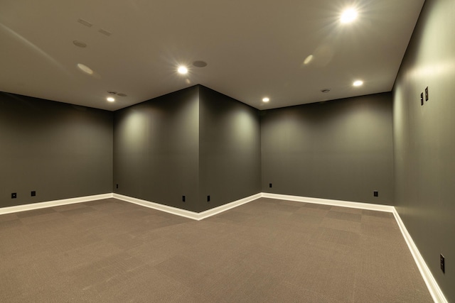 spare room with recessed lighting, carpet, and baseboards