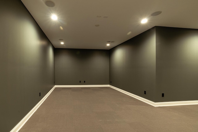 carpeted spare room featuring recessed lighting and baseboards