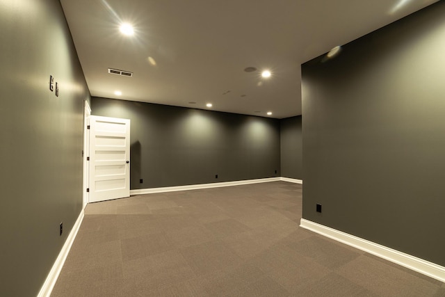 carpeted spare room with recessed lighting, visible vents, and baseboards