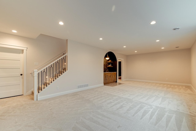 interior space with visible vents, stairway, light colored carpet, and recessed lighting