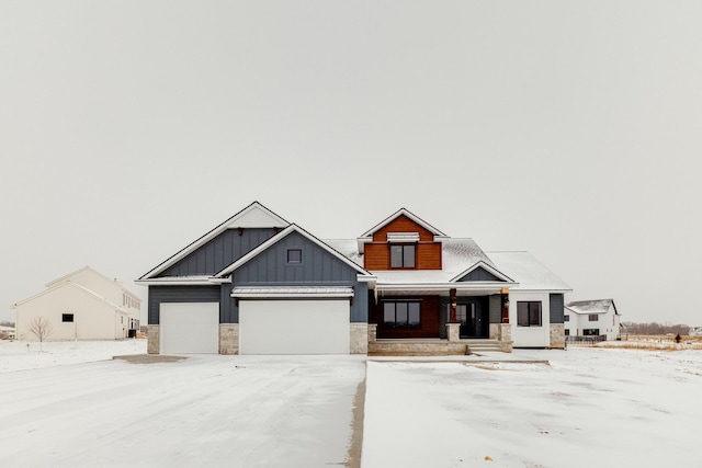 craftsman-style home featuring stone siding, board and batten siding, and an attached garage