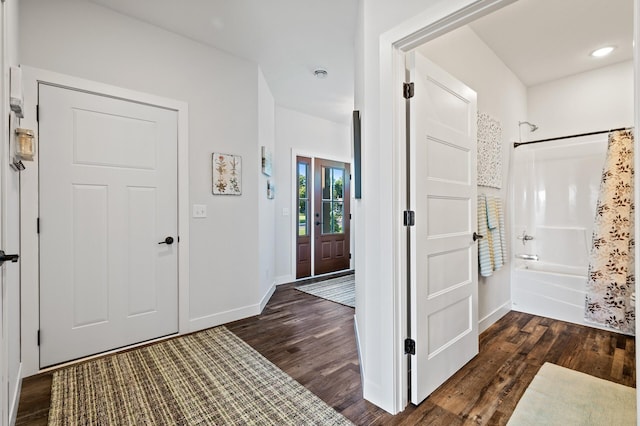 entryway with dark hardwood / wood-style flooring