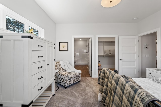 bedroom featuring connected bathroom and carpet flooring