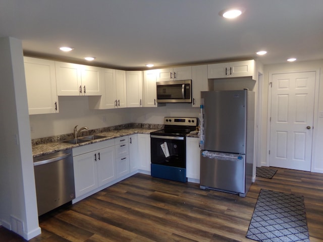 kitchen with white cabinets, sink, dark wood-type flooring, and stainless steel appliances