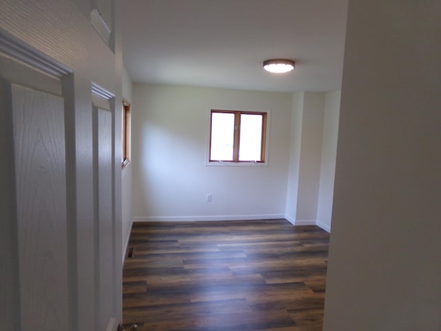 empty room with dark hardwood / wood-style floors