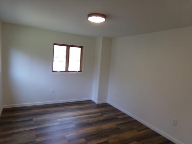 unfurnished room featuring dark hardwood / wood-style floors