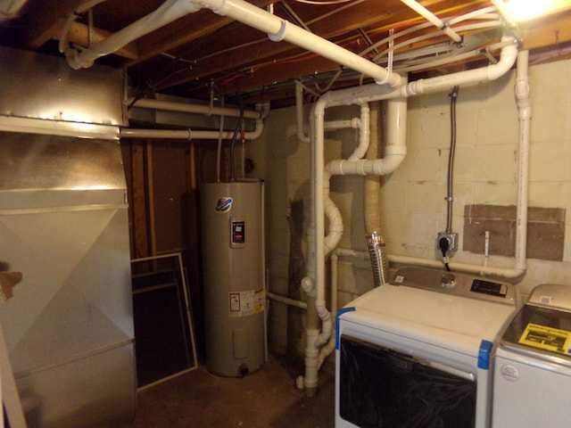 basement with washing machine and dryer and water heater