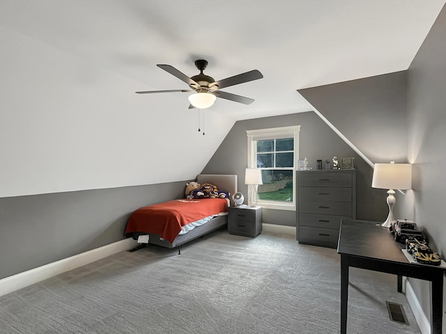 carpeted bedroom featuring lofted ceiling, a ceiling fan, visible vents, and baseboards