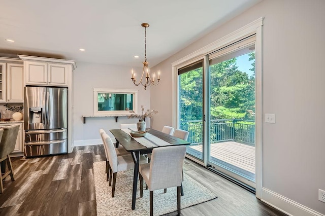 dining space with a chandelier, recessed lighting, dark wood-style flooring, and baseboards