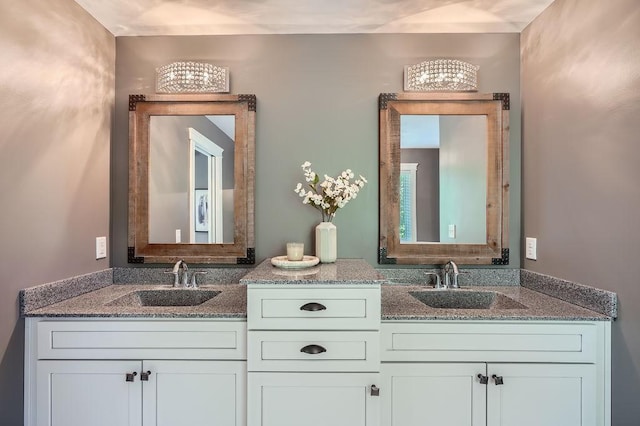 full bathroom with double vanity and a sink