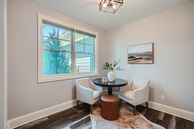 sitting room featuring baseboards and dark wood-type flooring