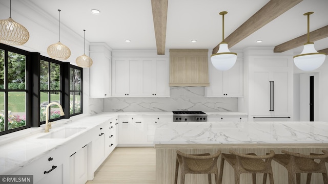 kitchen with white cabinetry, sink, light stone countertops, and custom range hood