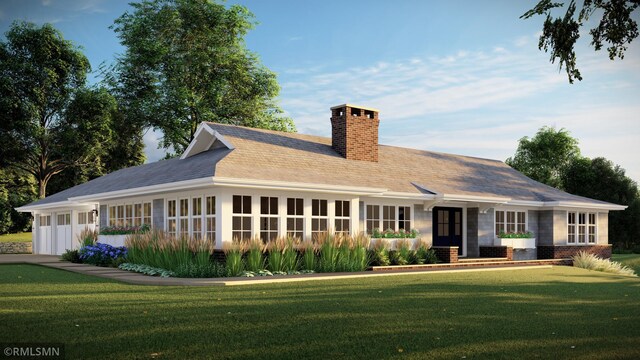 view of front of home featuring a garage and a front lawn