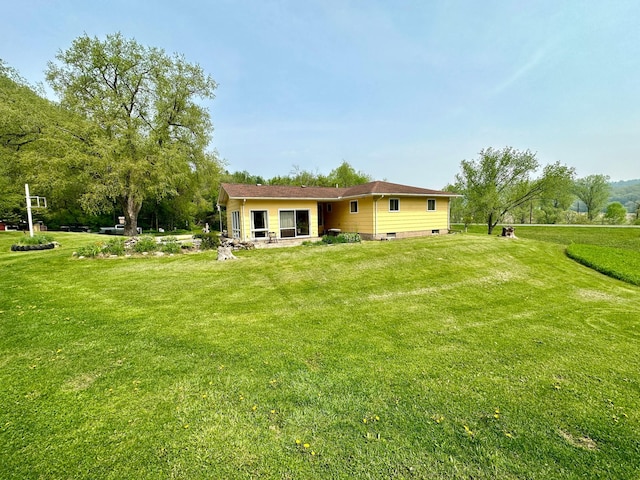 rear view of house with a yard