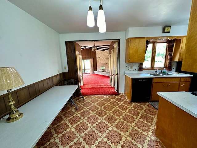 kitchen with ceiling fan, carpet flooring, pendant lighting, black dishwasher, and sink