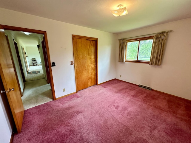 unfurnished bedroom with a closet and carpet floors