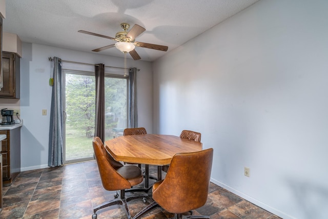 dining room with ceiling fan and a textured ceiling