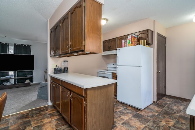 kitchen featuring dark colored carpet, kitchen peninsula, white appliances, and a textured ceiling