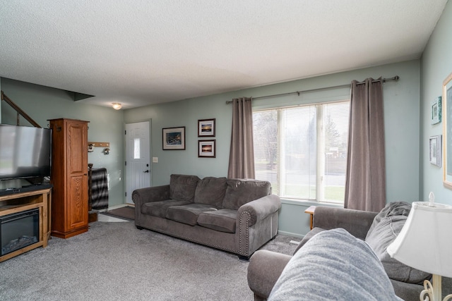 carpeted living room with a textured ceiling and a wealth of natural light