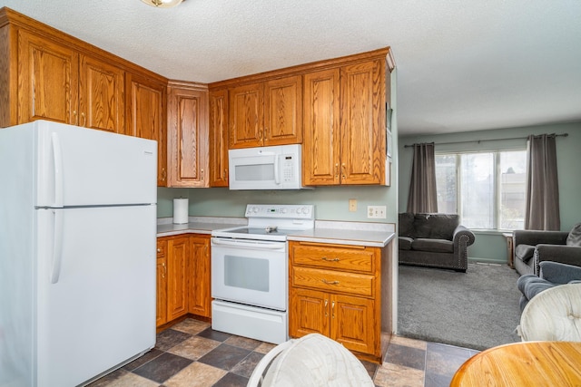 kitchen featuring white appliances and a textured ceiling