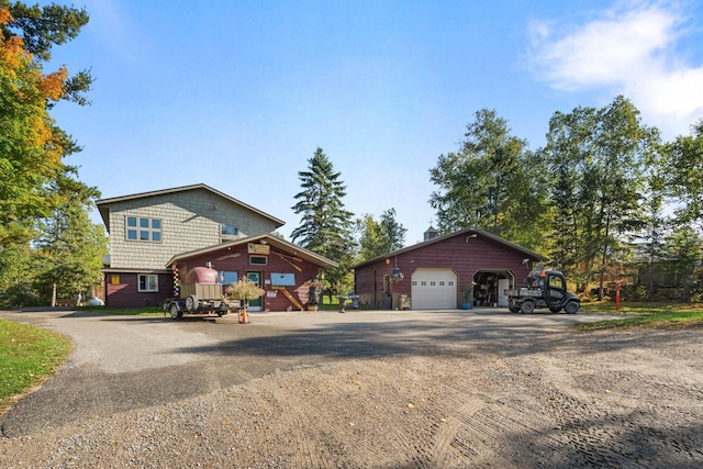 view of front facade featuring a garage and an outdoor structure